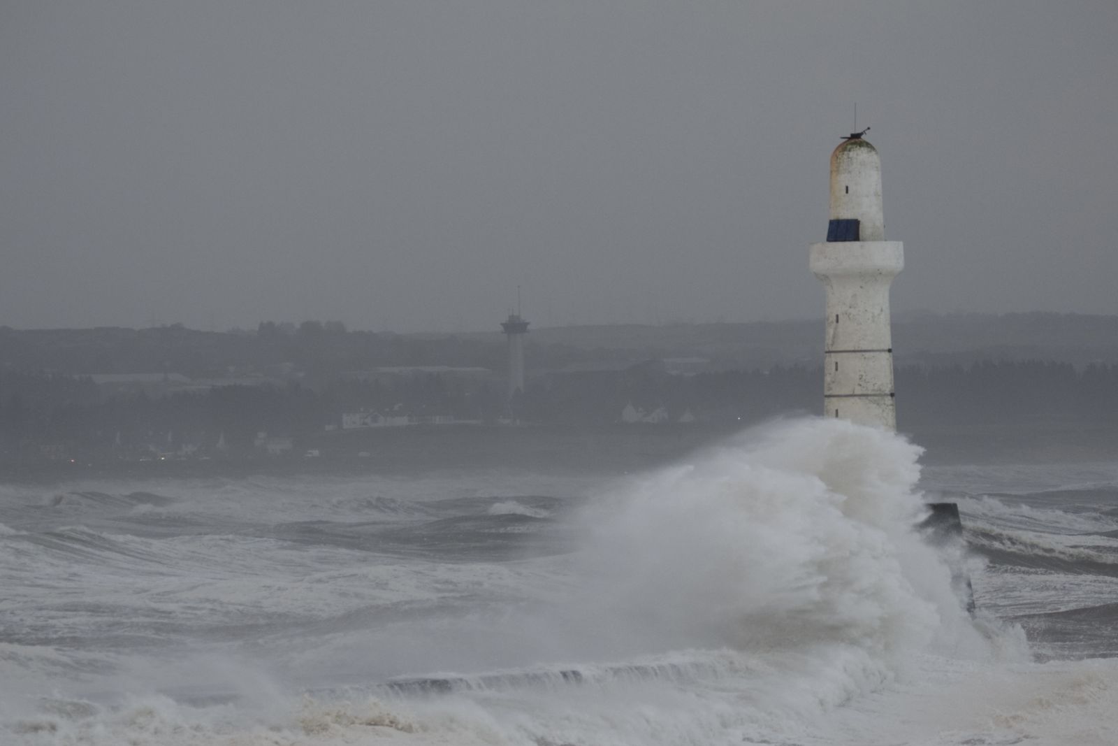 Waves crashing around Aberdeen lighthouse banner image